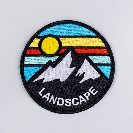 Embroidered mountain landscape patch laid flat