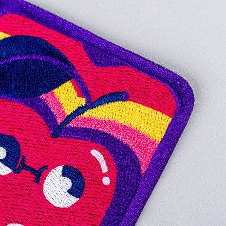 Embroidered PHOU cherry patch close up