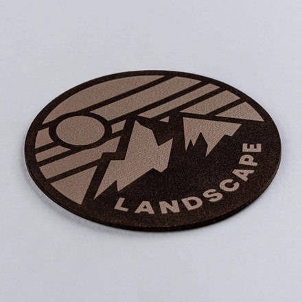 Taupe Genuine Leather with high contrast mountain landscape patch laid at a hard angle