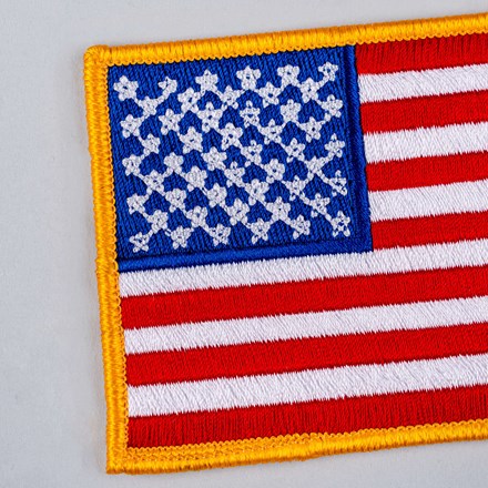 Embroidered American Flag Patch with yellow border close up