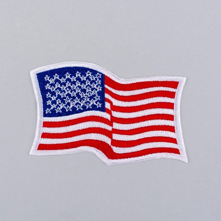 Embroidered Wavy American Flag Patch with white border laid flat