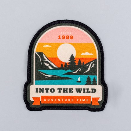 Sublimated Faux Suede Into the Wild Adventure Patch laid flat