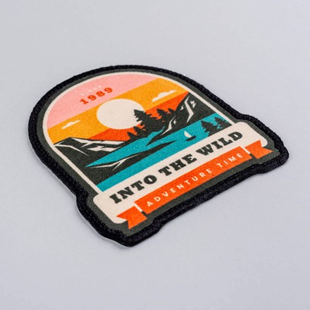 Sublimated Faux Suede Into the Wild Adventure Patch laid at a hard angle