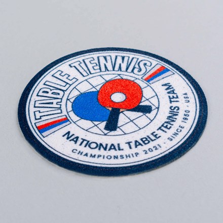 Sublimated Faux Suede National Table Tennis Team patch laid at a hard angle