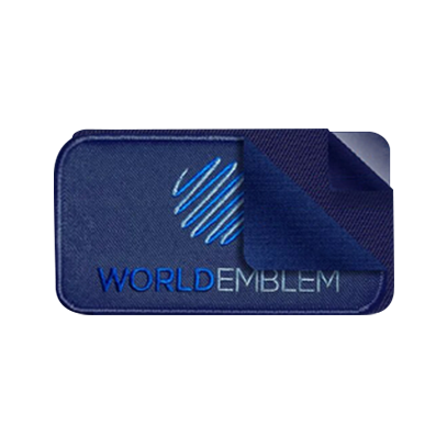 World Emblem patch with the application layers pulled back to show the patch, glue blocker, and glue