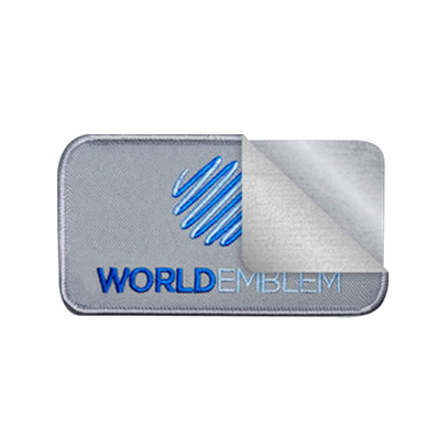 World Emblem patch with the application layers pulled back to show the patch, and heat seal strip below