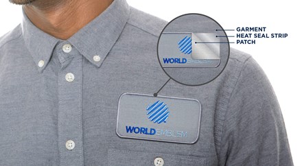 Man in polo shirt with a World Emblem patch with the application layers pulled back to show the patch, and heat seal strip below